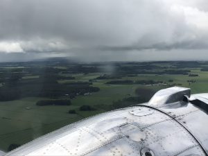View from the DC-3 cabin outside flying over Finnish countryside